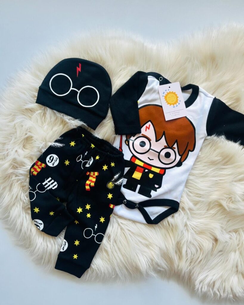 Harry Potter themed baby clothes including a bodysuit, pants, and beanie on fur.